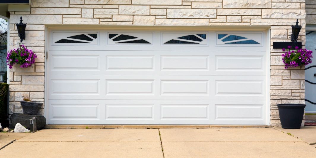 Raised panel overhead door. Garage door with window inserts. Traditional overhead doors. Repair.